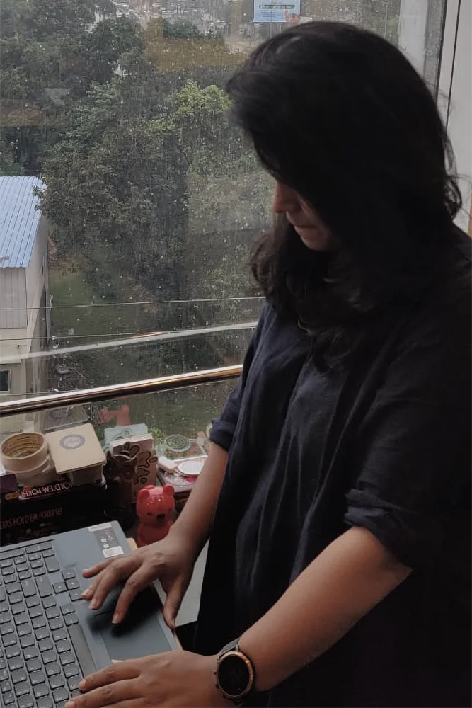 Designer working on a laptop with a view