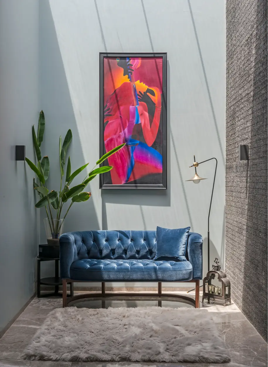 Front view of the blue couch and wall hanging Art from the ADND project