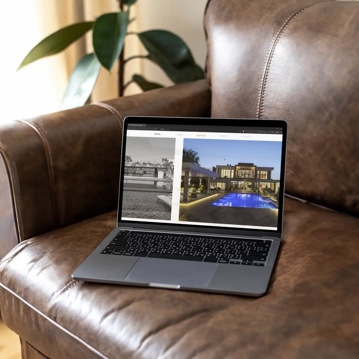 Laptop on Brown Couch shows ADND work on website