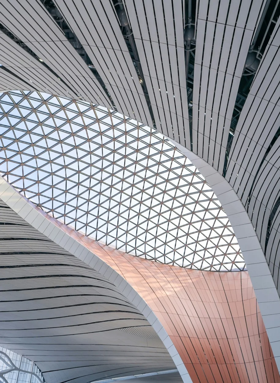 Architectural detail of a modern building with a complex geometric ceiling structure