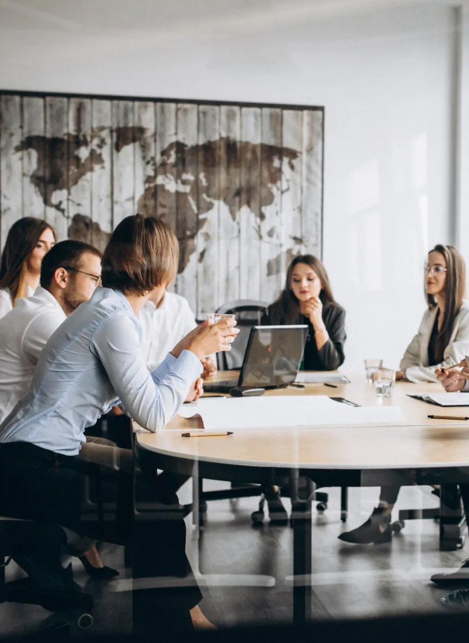 Business team in a conference meeting discussing around a table.